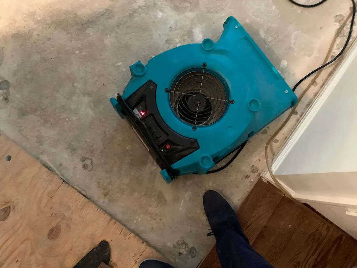 Air mover drying subfloor during Leak Detection & Repair in Cumberland